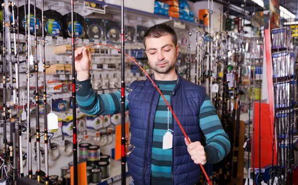 customer buying gear in a recently opened fishing shop