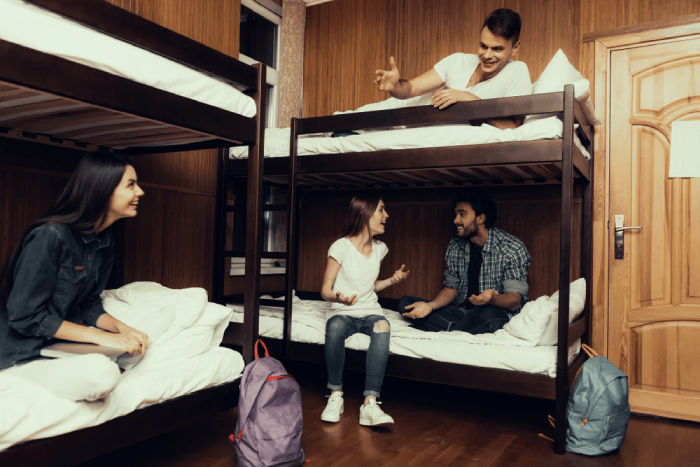young people having a chat in a hostel dormitory - open a hostel