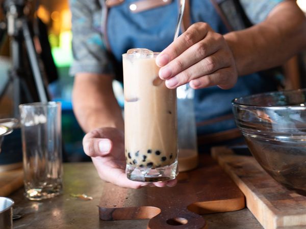 entrepreneur serving bubble tea to a customer