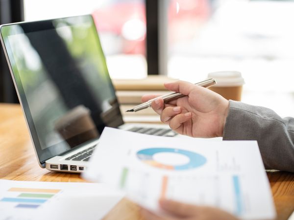 entrepreneur formatting their business plan on their laptop