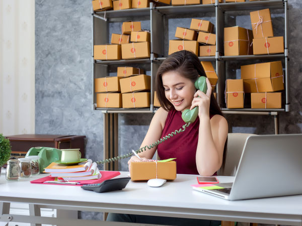 entrepreneur selling their products through telephone whilst running their business